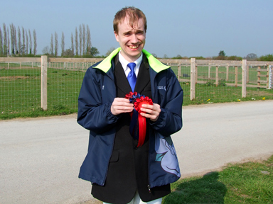 Oliver with his prize rosettes