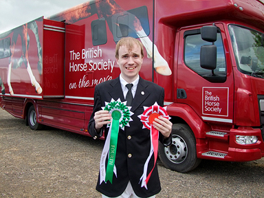 Oliver with his prize rosettes