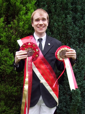 Oliver and his Championship rosettes and sash