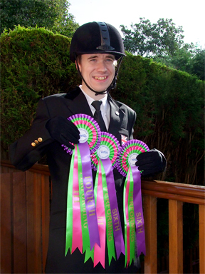 Oliver with his prize rosettes