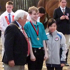 Oliver receives his medals from the Mayor and Hong Kong Paralympian