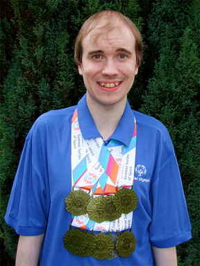 Oliver proudly wearing his Summer Series of Sport medals